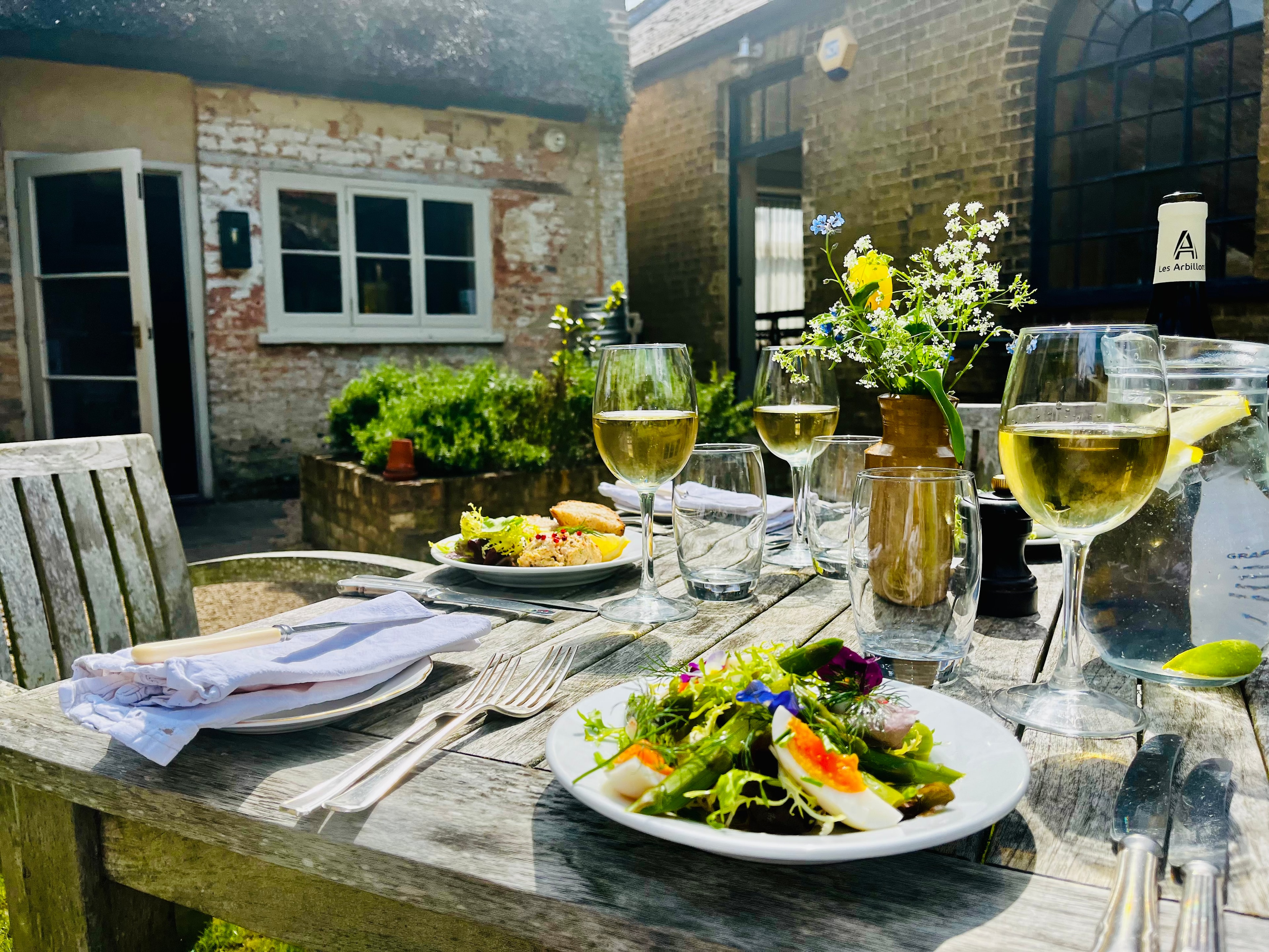 Al fresco dining in the courtyard with wine and asparagus salad