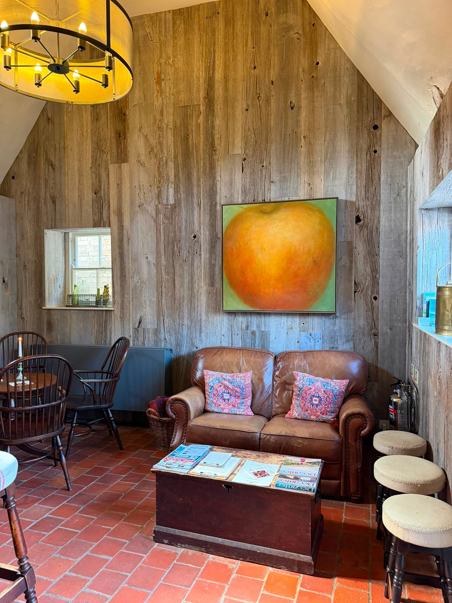 The Red Lion snug with original artwork and reclaimed timber walls