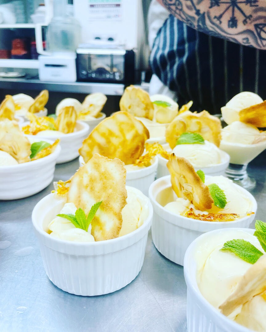 Lemon posset with caramelised tuile and mint garnish