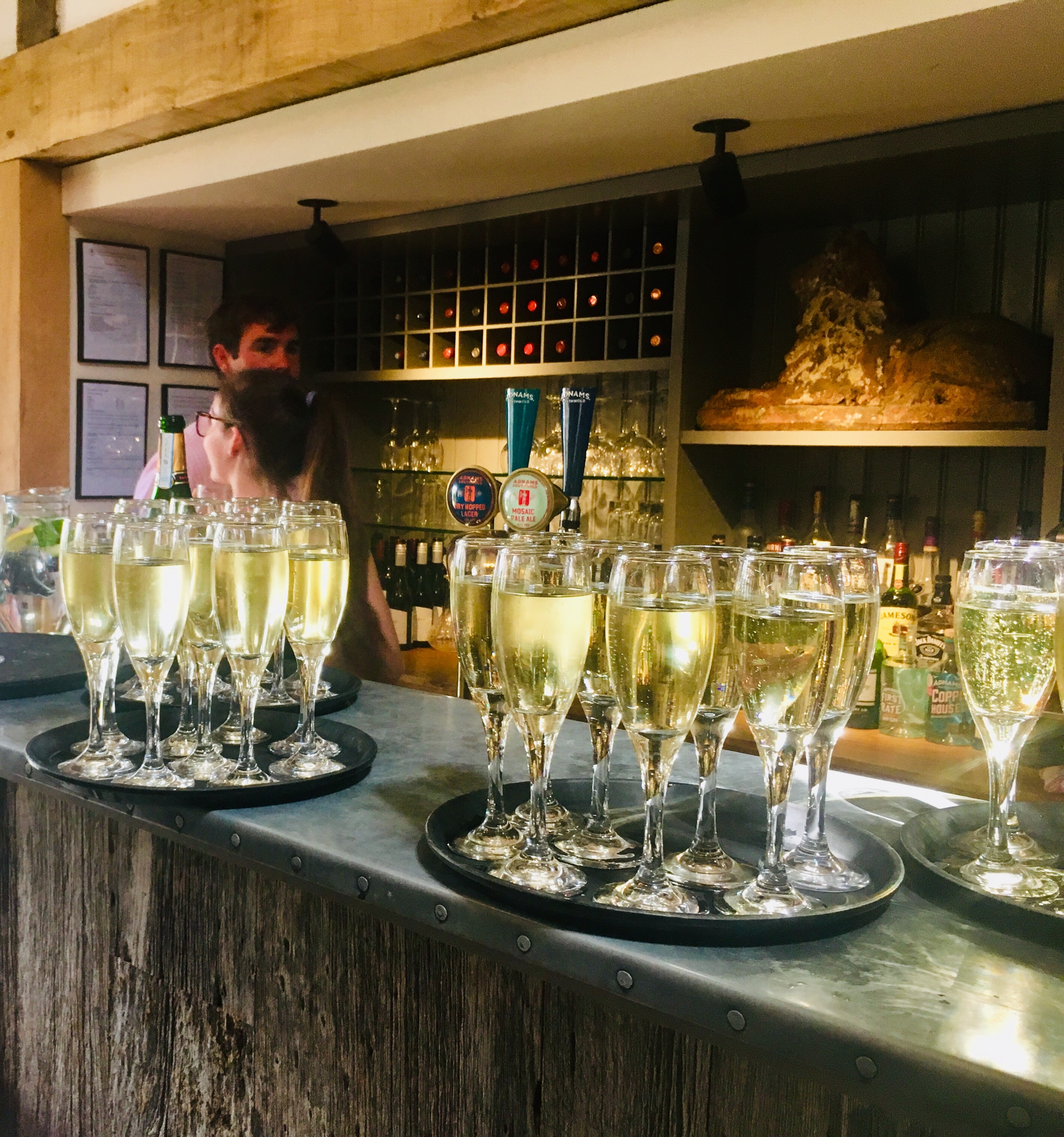 Champagne flutes lined up on the bar for a private event at The Red Lion